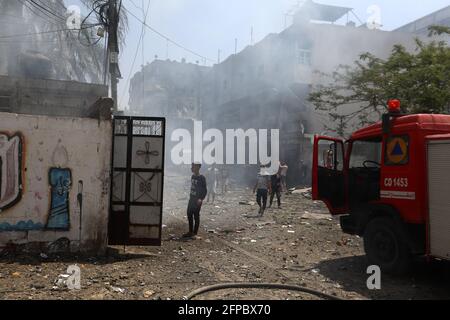 Smoke rises from a 14-story building as Israeli fighter jets continue to pound a Palestinian building called 'Ash-Shuruq' at Omar Al-Mukhtar neighborhood. Gaza Strip. Stock Photo