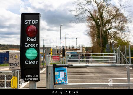 Woodbridge, Suffolk, UK April 09 2021: A traffic light system at a foot crossing on a train line allowing pedestrians to cross safely Stock Photo