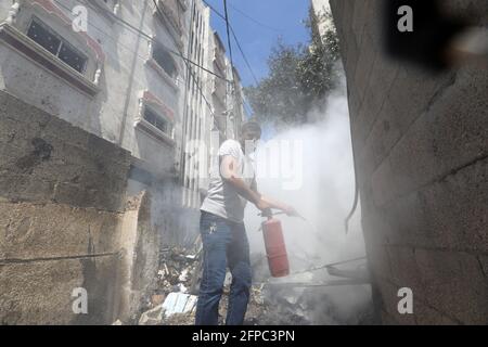 Smoke rises from a 14-story building as Israeli fighter jets continue to pound a Palestinian building called 'Ash-Shuruq' at Omar Al-Mukhtar neighborhood. Gaza Strip. Stock Photo