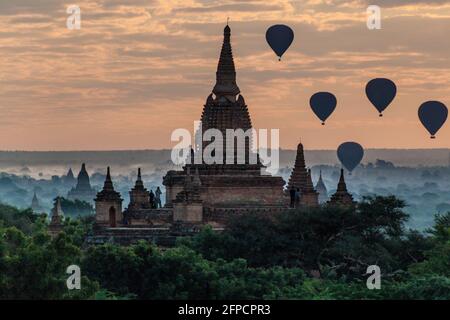 Balloons over Bagan and the skyline of its temples, Myanmar. Myauk Guni Temple. Stock Photo