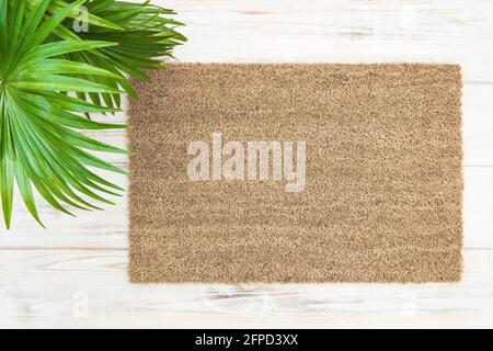 Coir doormat mockup with palm leaves decoration. Floral template mock up