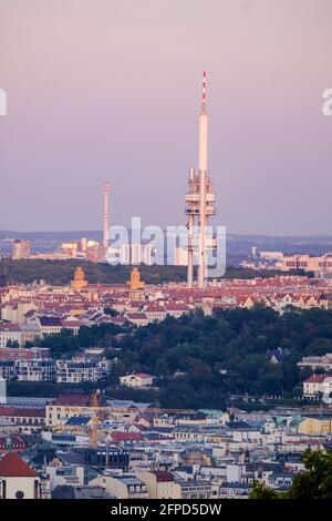 An early evening view over the city of Prague from the viewing platform at Petrin Tower where Brutalist style Zizkov TV Tower can been seen. Stock Photo