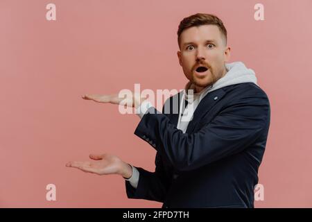 Impressed man presenting something and being in shock Stock Photo