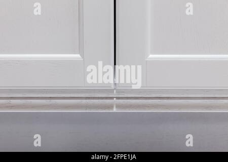 Close-up closed doors of white modern kitchen cabinet. Abstract view wooden kitchen with textured. Stock Photo