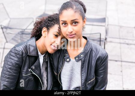 Two north African teen friends sitting together talking Stock Photo