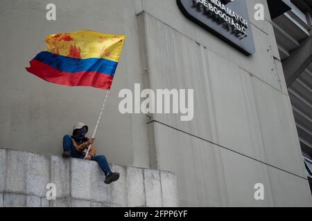 Bogota, Cundinamarca, Colombia. 19th May, 2021. Protester waves the Colombian flag as protests increase in BogotÃ¡ on May 20, 2021 in the context of a national strike in Colombia against the tax reform and the government of IvÃ¡n Duque. Credit: Daniel Romero/LongVisual/ZUMA Wire/Alamy Live News Stock Photo