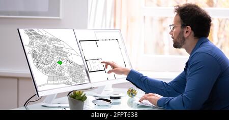 Developer Looking At Land Plot Map And Cadastre Plan Stock Photo