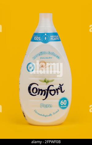 A bottle of Comfort Pure fabric conditioner shot on a yellow background. Stock Photo