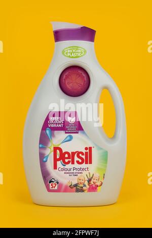 A bottle of Persil Colour Protect biological liquid laundry detergent shot on a yellow background. Stock Photo