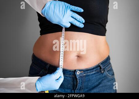 Loose Waist Care By Doctor In Clinic Stock Photo