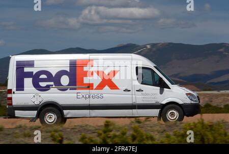 A Federal Express, or FedEx Express van makes deliveries in Santa Fe, New Mexico. Stock Photo
