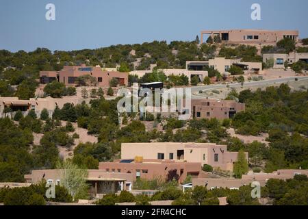 A neighborhood in Santa Fe, New Mexico, features flat-roofed, earth-hued homes reminiscent of the area's traditional 19th century adobe homes. Stock Photo