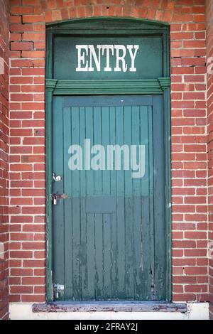 Green door entry to a Fremantle warehouse. Stock Photo
