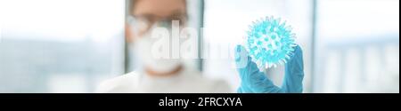 Coronavirus vaccine research lab woman researching looking at model of corona virus panoramic banner. In search of a cure research doctor holding blue Stock Photo