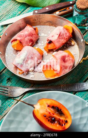 Tamarillo wrapped and baked with ham and bacon.Healthy food Stock Photo