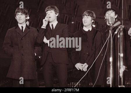 Beatles arriving at a press conference on February 11, 1964 before their first concert in America at the Washington Coliseum on February 11, 1964.  Pictured L to R are George Harrison, Paul McCartney, John Lennon, and Ringo Starr. (USA) Stock Photo