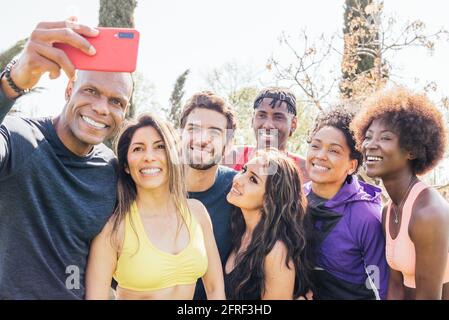 Group of runners taking a selfie in a park. Happy and smiling. Stock Photo