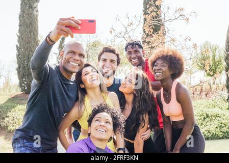 Group of runners taking a selfie in a park. Happy and smiling. Stock Photo