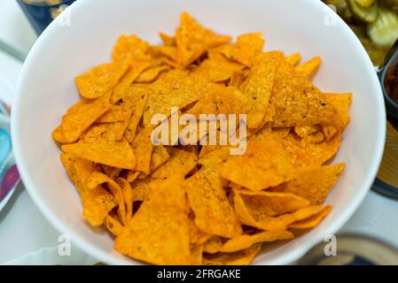 Heap of crackers in white plate on a table. Top view. Stock Photo