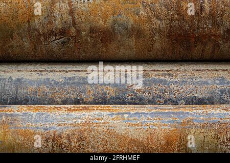 close up of a texture of steel pipes, gray, steel gray and rust colored Stock Photo