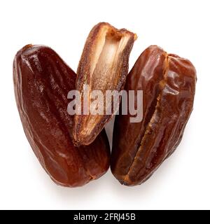 Two and half dry pitted dates isolated on white. Top view. Stock Photo