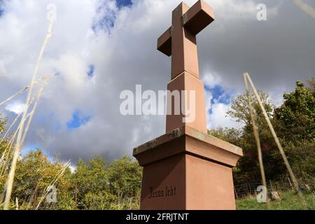 Stone cross in the Palatinate Forest (Germany) with the inscription Jesus lebt (Jesus lives) Stock Photo
