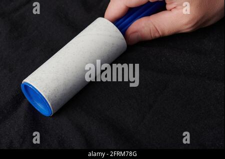Cleaning service of black fabric from fur or dust theme Stock Photo