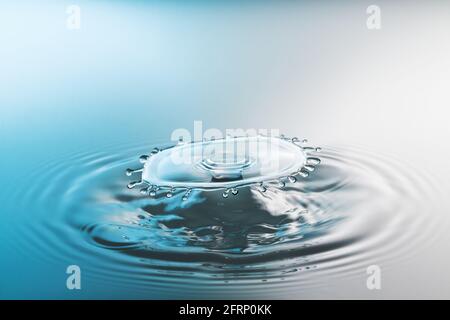 Collision ripple splash of two drops falling into the water Stock Photo