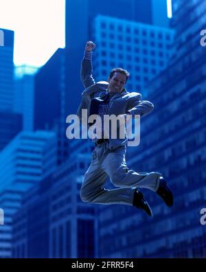 2005 HISTORICAL AIRBORNE OFFICE WORKER JUMPING IN MID AIR OFFICE BUILDINGS MANHATTAN NEW YORK CITY USA Stock Photo