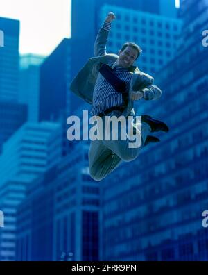 2005 HISTORICAL AIRBORNE OFFICE WORKER JUMPING IN MID AIR OFFICE BUILDINGS MANHATTAN NEW YORK CITY USA Stock Photo