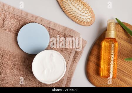 spa and body care products with towel and plant aloe vera on gray background Stock Photo