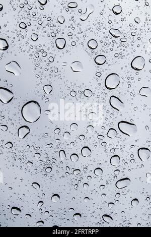Rain droplets on a window during a spring rain storm Stock Photo