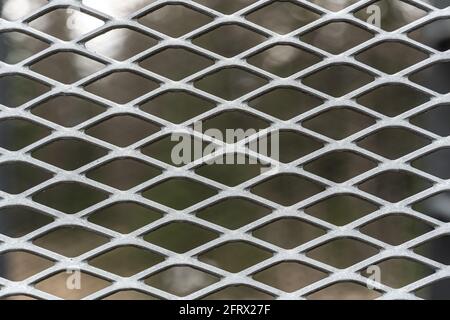 Metal mesh grid in weathered stained steel. Close up. Stock Photo