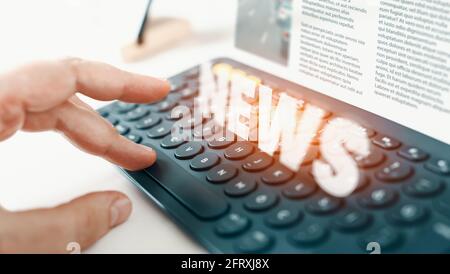 Holographic online breaking news concept: Man hand touching computer key on keyboard. Global communication media, broadcast concept. Stock Photo