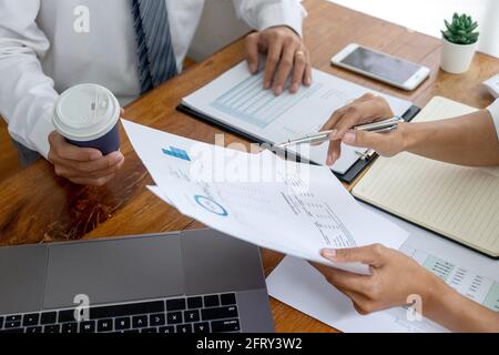 young business team in casual style have small meeting in the office talk about  analyses chart graph marketing plan with computer laptop calculator a Stock Photo