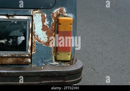 Tail lamp and signal lights of an old and rusty car. Vintage car background. Stock Photo