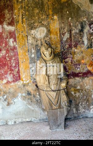 Statue of a youth with a cloak covering his head. The statue of Hermes, the god of the palaestra in his guise as Psychopompus, the guide of departed souls. Stabian Baths (terme Stabiane) - Pompeii archaeological site, Italy Stock Photo