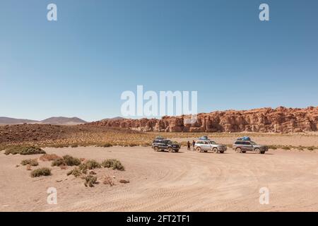 Three SUV 4x4 off-road vehicles are parked in the Bolivian desert Stock Photo