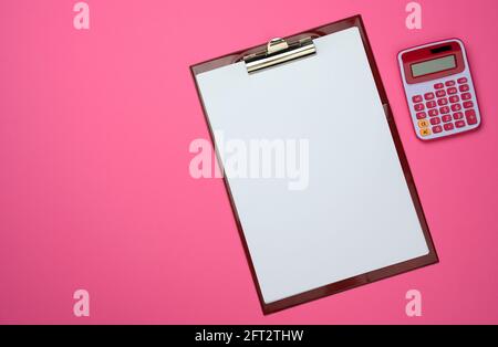 plastic pink calculator and folder with blank white sheets on pink background, top view Stock Photo