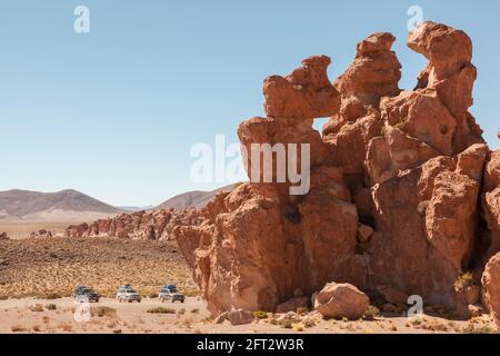 Three SUV 4x4 vehicles are parked at a rocky location in the Bolivian desert Stock Photo