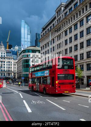 Stormy Skies over the City of London Financial District. a Red London bus in the City of London Financial District. Stock Photo