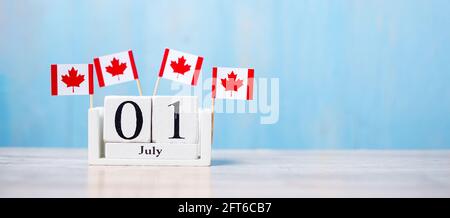 Wooden calendar of July 1st with miniature Canada flags. Canada Day  and happy celebration concepts Stock Photo