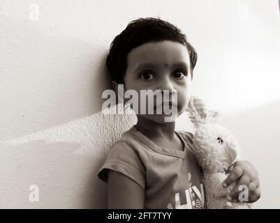 a close view of Indian girl child holding toy in black and white photo, Kalaburagi, Karnatka, India-May 10.2021 Stock Photo