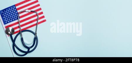 USA medicine background. Stethoscope on the American flag. Healthcare and medical services in the USA concept. High quality photo Stock Photo