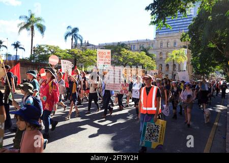 Brisbane, Australia. 21st May, 2021. Protesters hold placards while marching through the Street during the demonstration.Thousands of students and their supporters have walked out of classrooms and workplaces to join School Strike 4 Climate events around the country, becoming part of a global youth-led movement pleading for urgent action on climate change. (Photo by Joshua Prieto/SOPA Images/Sipa USA) Credit: Sipa USA/Alamy Live News Stock Photo