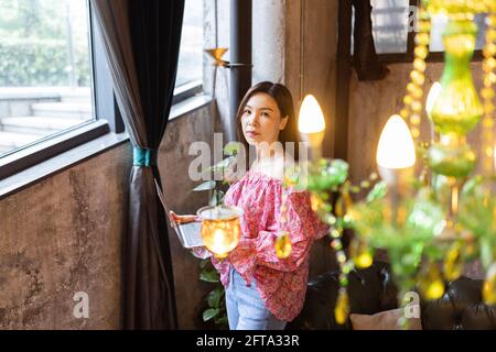 Pretty young asian business woman using laptop in modern cafe.  Stock Photo