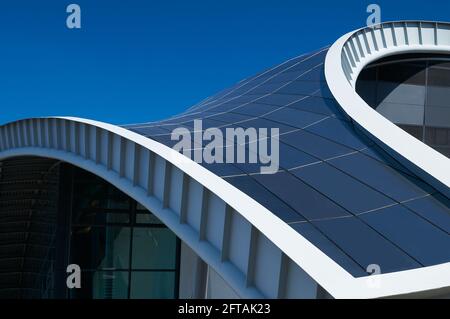 Gateshead, United Kingdom - April 6th 2019: Close-up of the curved steel roof line of the Sage building in Gateshead, against a blue sky. Stock Photo