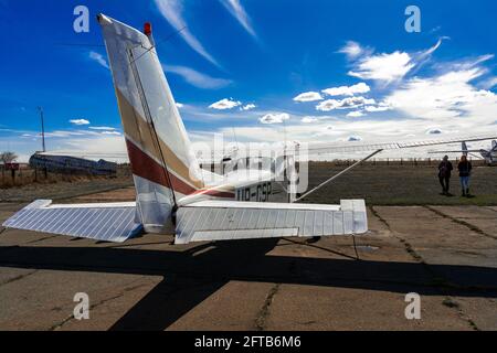 Kiev, Ukraine, 04 April 2021 - Airfield Chaika, Light aircraft before takeoff, rear view. Spring sunny day, plane under blue sky with white clouds. Stock Photo