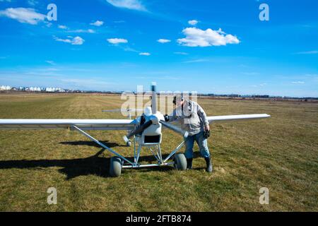 Kiev, Ukraine, 04 April 2021 - Airfield Chaika, an operator with an unmanned airplane on the runway. A man is flying an unmanned aircraft designed for Stock Photo