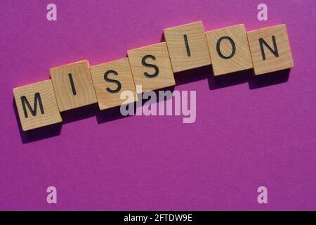 Mission, word in wooden alphabet letters isolated on purple background with copy space Stock Photo